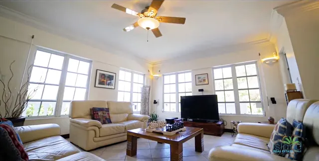Living room with high ceiling and large windows