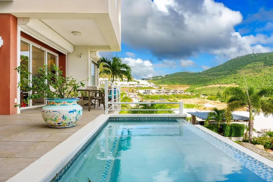 Mosaic-edge plunge pool overlooking the hillside villas of Indigo Bay