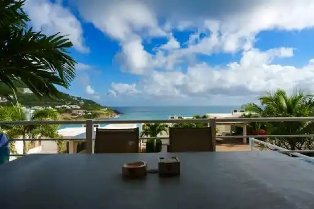 Table on a villa terrace overlooking the bay at Indigo Bay, Sint Maarten