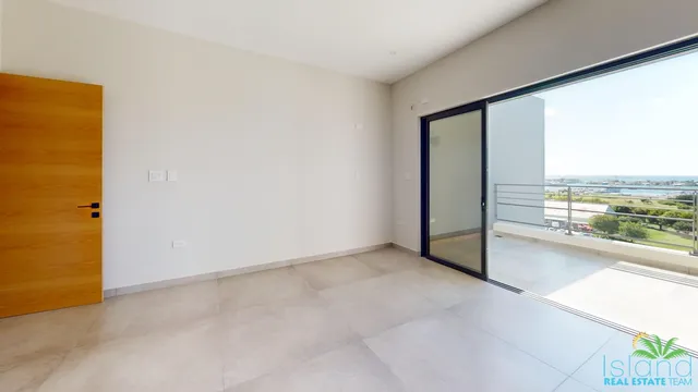 Bedroom with sliding glass doors to the terrace at Plumbago Residences