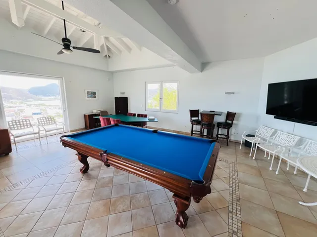 Games room with pool table and windows to the sea