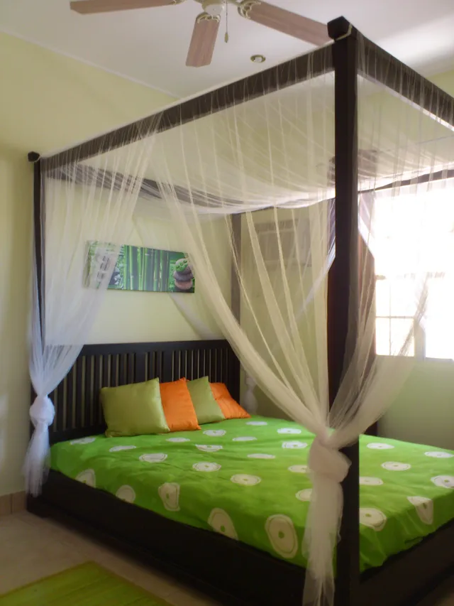 Bedroom with a four-poster bed in a White Sands apartment